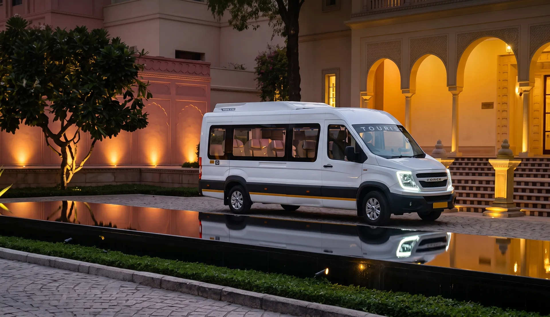 The Luxury Maharaja Urbania exterior parked in front of an Indian palace at sunset